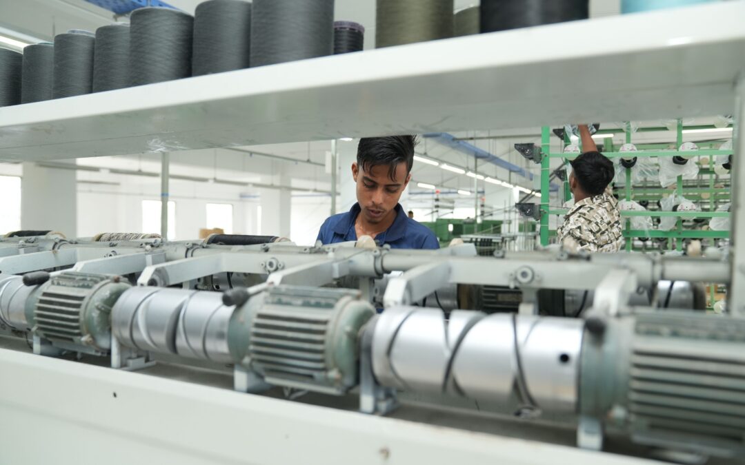 Industrial factory interior with workers operating machinery